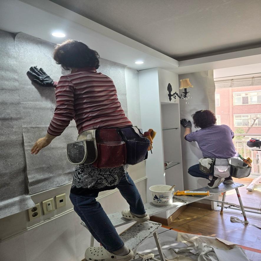 전문가가 벽지 시공을 진행하는 과정